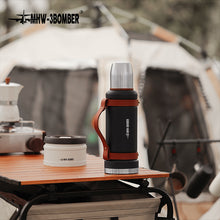 Load image into Gallery viewer, MHW-3BOMBER Outdoor Thermoskanne 1.2 L schwarz auf Outdoor Campingtisch